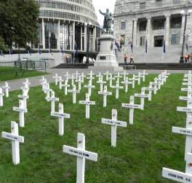 Seddon Statue overlooks Field of White Crosses in Parliament Grounds.